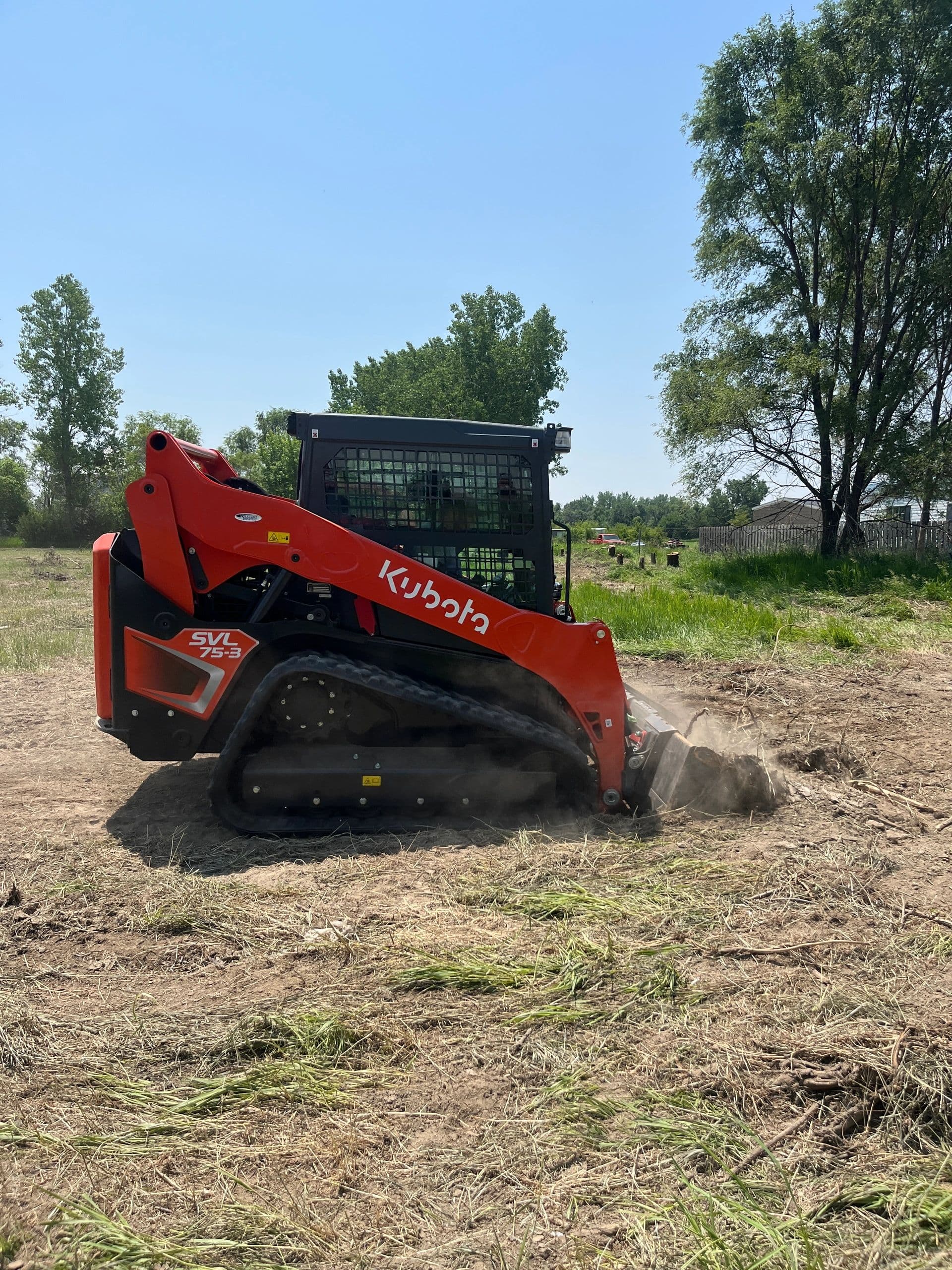 Skid-loader attachments lined up at the yard